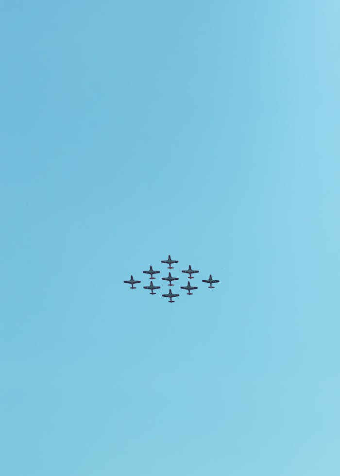 Stunt planes in perfect formation against a clear blue sky in Toronto, Canada.